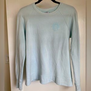 ATHLETA GIRL COZY CROSS YOUR FINGERS SWEATSHIRT.Girls xxl, light blue. W/ design